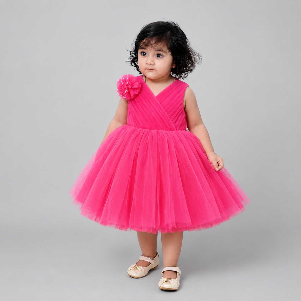 Toddler girl wearing Bubblegum Fairy Dress in bright pink tulle with floral shoulder detail